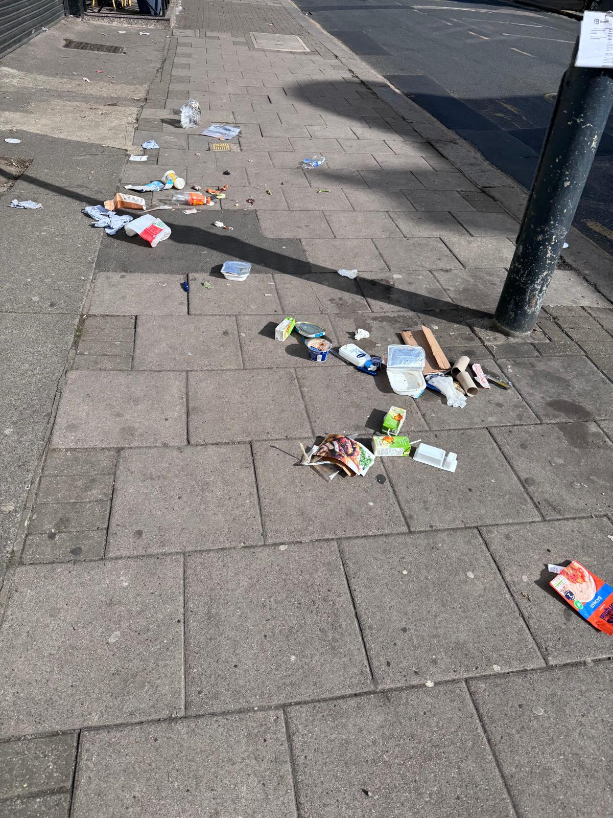 Food packaging scattered along a pavement